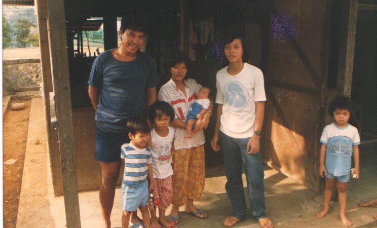 My family in the relocation camp in the Philippines after we were accepted to migrate to America. I am the infant in my mother's arms. My father is on the far left, my uncle next to my mom, my oldest sister (3) and older brother (2). A neighborhood kid on the far right.
